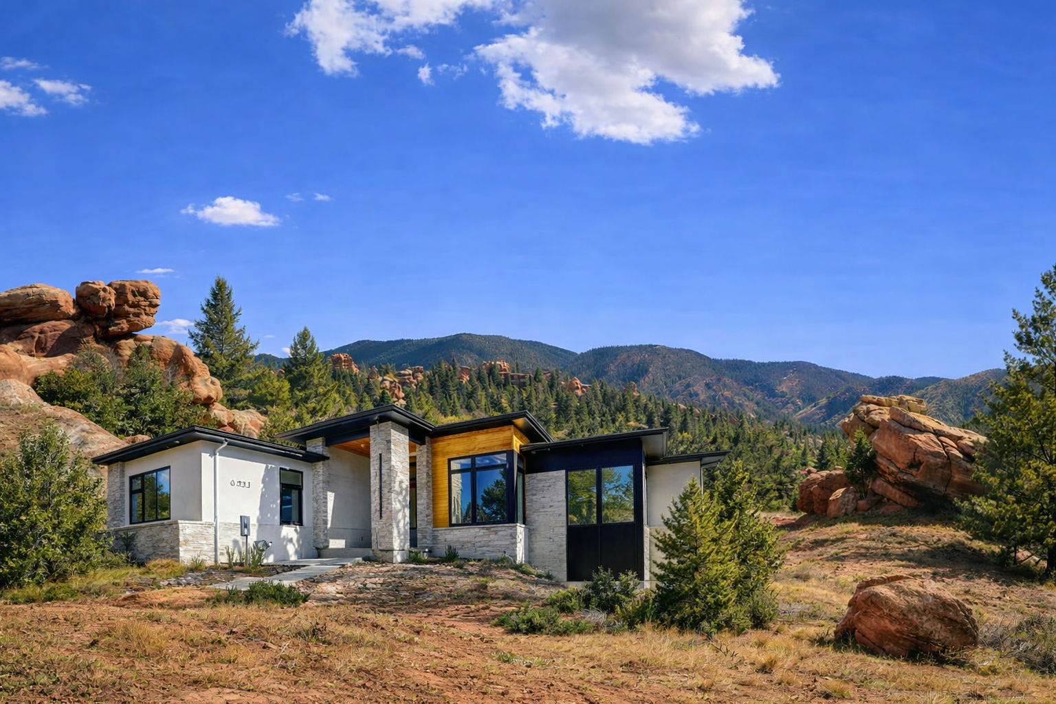 Modern ranch home set among red rock formations and foothills in Larkspur, Colorado